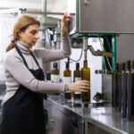 Skilled,Woman,Engaged,In,Olive,Oil,Production,,Controlling,Process,Of