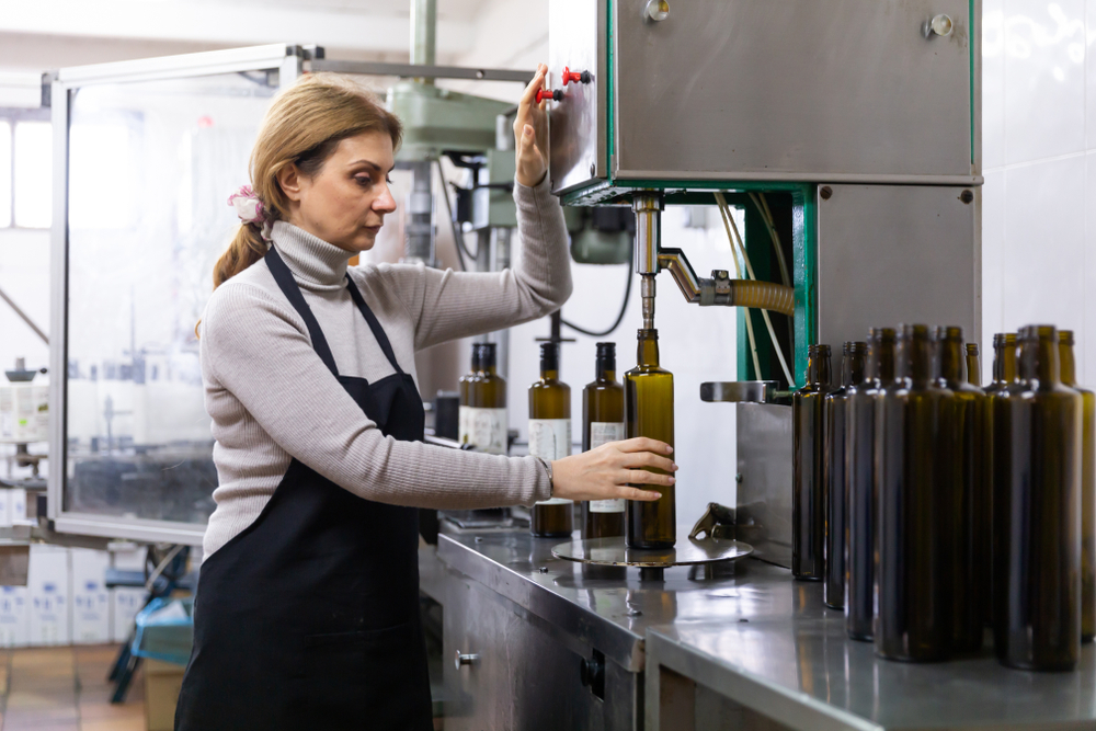 Skilled,Woman,Engaged,In,Olive,Oil,Production,,Controlling,Process,Of